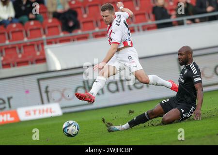 Benjamin Kallman of Cracovia (L) and Mike Cestor of Radomiak (R ) seen in action during Polish PKO Ekstraklasa League 2023/2024 football match between Cracovia Krakow and Radomiak Radom at Cracovia Stadium. Final score; Cracovia Krakow 6:0 Radomiak Radom. Credit: SOPA Images Limited/Alamy Live News Stock Photo