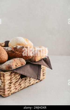 Assorted bakery products including loafs of bread,  baguette and rolls in basket, top view Stock Photo