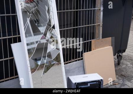broken mirror, bulky waste, old furniture, tables, used things on street before collected, problem of shredding garbage, collecting and recycling bulk Stock Photo