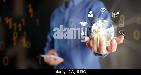 Global internet connection concept. Internet usage worldwide in business and technology. A man hand holds virtual globe with internet icons linked or Stock Photo