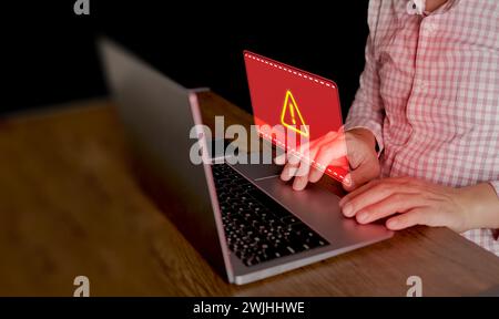 Cyber security concept. Red system hacked warning sign alerts on a computer notebook screen. Cybercrime, virus, online hacking, cyber attack, maliciou Stock Photo