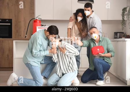 People choking on smoke in burning kitchen Stock Photo