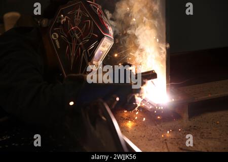 240214-N-VR794-1207 SAN DIEGO (Feb. 14, 2024) – Hull Maintenance Technician 3rd Class Gabriel Alejo, from Orange, California, welds a washing machine to a mount aboard amphibious assault carrier USS Tripoli (LHA 7), Feb 14. Tripoli is an America-class amphibious assault ship homeported in San Diego. (U.S. Navy photo by Mass Communication Specialist Seaman Apprentice James Peer) Stock Photo