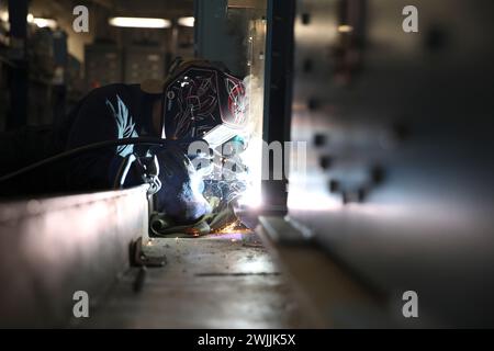 240214-N-VR794-1166 SAN DIEGO (Feb. 14, 2024) – Hull Maintenance Technician 3rd Class Gabriel Alejo, from Orange, California, welds a washing machine to a mount aboard amphibious assault carrier USS Tripoli (LHA 7), Feb 14. Tripoli is an America-class amphibious assault ship homeported in San Diego. (U.S. Navy photo by Mass Communication Specialist Seaman Apprentice James Peer) Stock Photo