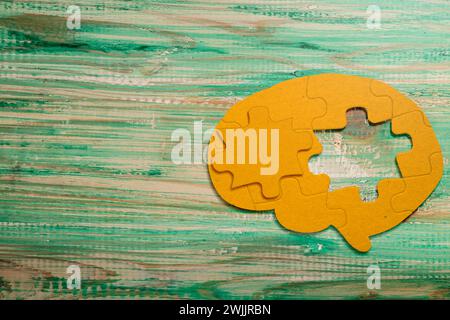 The missing piece of the brain puzzle is on the table. Mental health concept Stock Photo