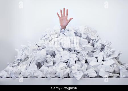 Person, hand and paper pile or trapped in deadlines for work responsibilities for overwhelmed, exhausted or problem. Fingers, buried and employee Stock Photo
