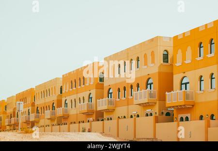 Villas compound development in a bright sunny day. Living house with apartments and balconies in Arabic style. Nobody, street photo Stock Photo