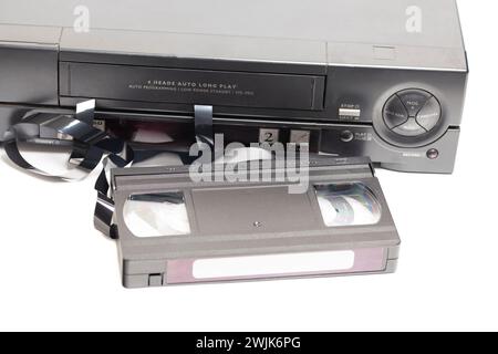 Retro video cassette recorder with VHS cassette with unwound tape isolated on white background Stock Photo