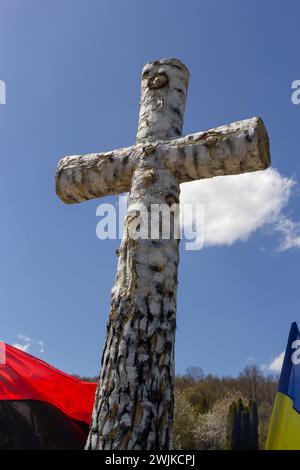 birch cross on the grave, cemetery, on the background of the sky. Ukraine. Stock Photo