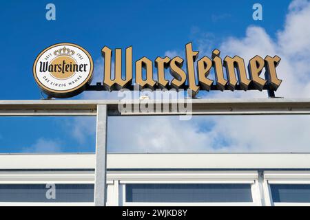 Warsteiner premium beer sign logo and brand text on restaurant terrace railing. Warsteiner is a brewery in Warstein, Germany, in the Sauerland. Stock Photo