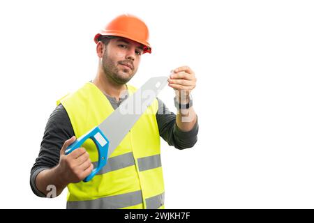 Adult male constructor wearing fluorescent vest and orange hardhat covering saw blade with blank copyspace isolated on white studio background Stock Photo