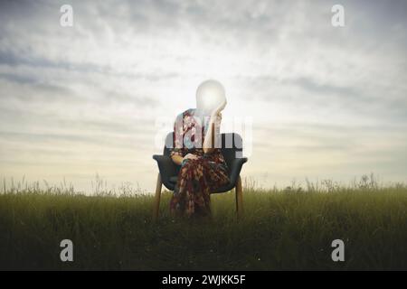 surreal woman has a lit light bulb in place of her face, concept of creative idea and success Stock Photo
