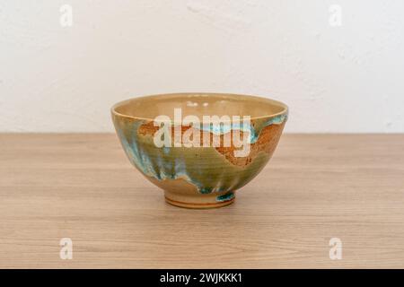 Colourful handmade ceramic bowl on wooden counter. High quality photo Stock Photo