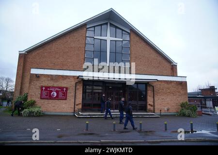 Police officers carry out security sweeps ahead of the Requiem Mass for former Rochdale MP and Greater Manchester mayor Tony Lloyd, at St Hugh Of Lincoln RC Church in Stretford, Manchester, following his death on January 17. Picture date: Friday February 16, 2024. Stock Photo