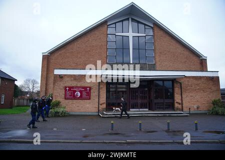 Police officers carry out security sweeps ahead of the Requiem Mass for former Rochdale MP and Greater Manchester mayor Tony Lloyd, at St Hugh Of Lincoln RC Church in Stretford, Manchester, following his death on January 17. Picture date: Friday February 16, 2024. Stock Photo