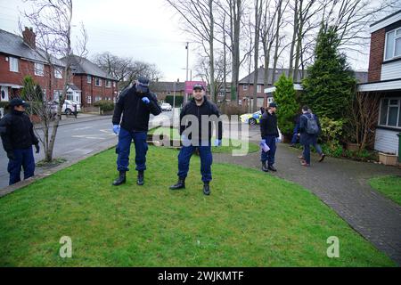 Police officers carry out security sweeps ahead of the Requiem Mass for former Rochdale MP and Greater Manchester mayor Tony Lloyd, at St Hugh Of Lincoln RC Church in Stretford, Manchester, following his death on January 17. Picture date: Friday February 16, 2024. Stock Photo