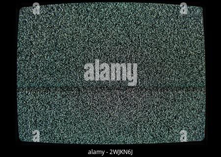 Television screen displaying static noise suggesting a signal disruption or no transmission Stock Photo