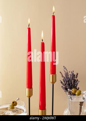 candles stand on the table in tall metal candlesticks. festive t Stock Photo