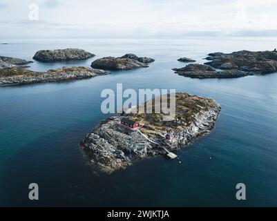 Drone shot of houses and rocks on island amidst sea Stock Photo