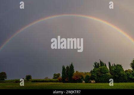 A rainbow over the Tuscan countryside in Fauglia, Pisa, Italy Stock Photo