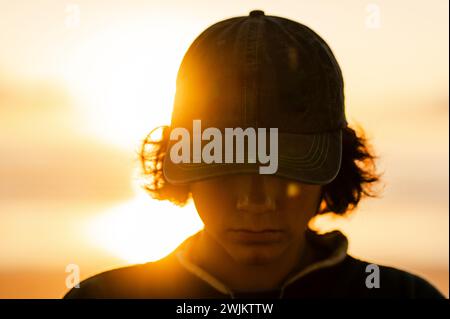 Sunset Glow and Cap Silhouette Stock Photo