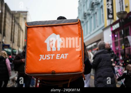 Just Eat rider on a push bike making a food delivery in Liverpool UK Stock Photo