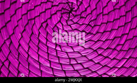 Spiral pattern of orchid  purple colored woven water hyacinth place mat Stock Photo
