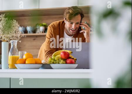 Adult man talking on smart phone while shopping online Stock Photo