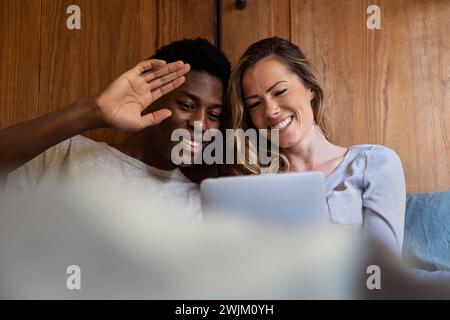 Young adult couple having a video call on digital tablet Stock Photo