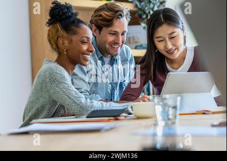 Coworkers using having a web conference together on digital tablet Stock Photo