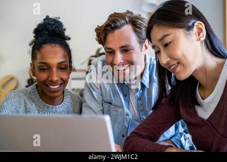 Coworkers having a web conference on digital tablet gathered at office Stock Photo