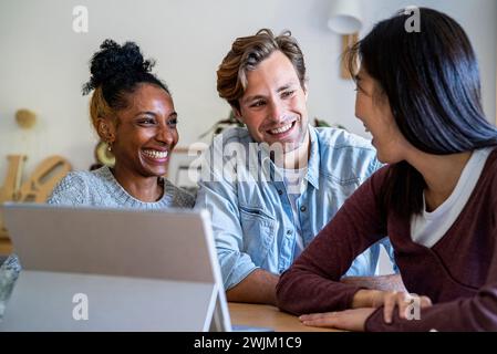 Female entrepreneur gathered with colleagues at office using digital tablet Stock Photo