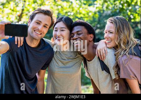 Young adult man taking a selfie with friends during hiking excursion Stock Photo