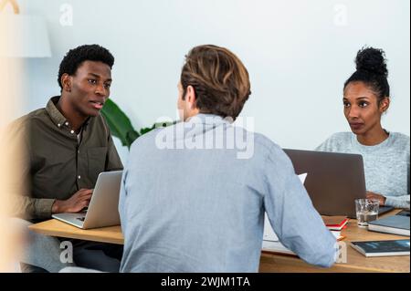 Group of business people discussing projecto while sitting in office Stock Photo