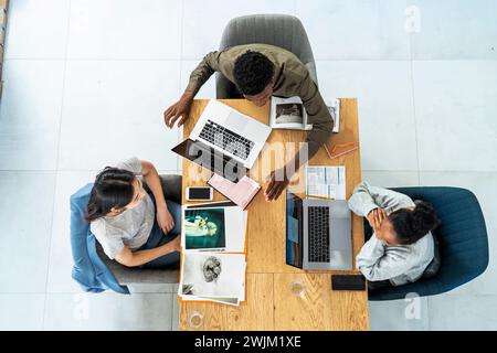 Advertising agency workers discussing project over laptop Stock Photo