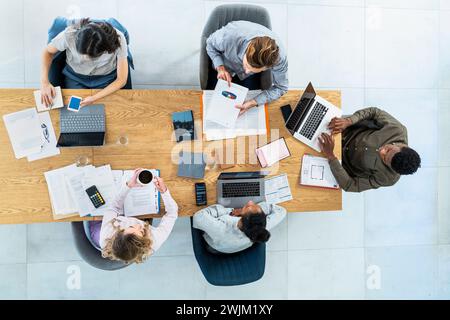 Financial team sitting at desk while working on project Stock Photo