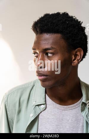 Front view portrait of serious young adult man looking to the side Stock Photo