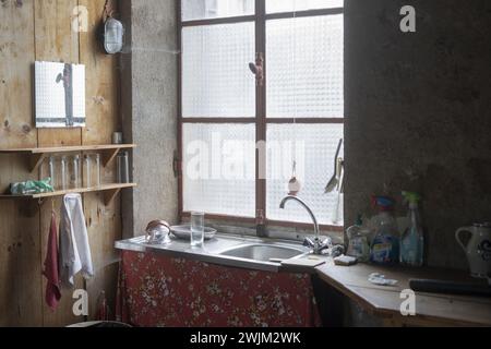 Empty kitchen with light coming through main window Stock Photo