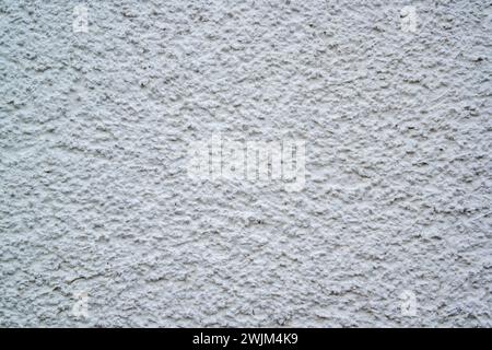 Textured plaster on a wall in the color white, texture background Stock Photo