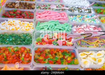 Colorful array of assorted gummy candies presented in containers, offering a variety of shapes and flavors for a sweet treat experience Stock Photo