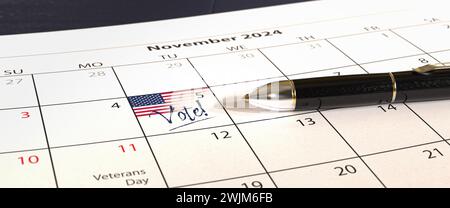 US presidential election will take place on November 5, 2024. A calendar with a US flag and the text 'Vote!' at the 5th of November. A pen lying on th Stock Photo
