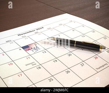 US presidential election will take place on November 5, 2024. A calendar with a US flag and the text 'Vote!' at the 5th of November. A pen lying on th Stock Photo