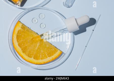 Petri dishes with orange research. Cut orange, research in the laboratory. Bioengineering, laboratory. AHA acids , cosmetics production. Stock Photo