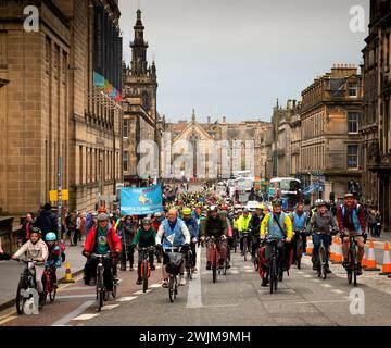 Hundreds of cyclists and people with bikes cycle through the streets of Edinburgh to the Parliament to protest and demonstrate for safer streets at an Stock Photo