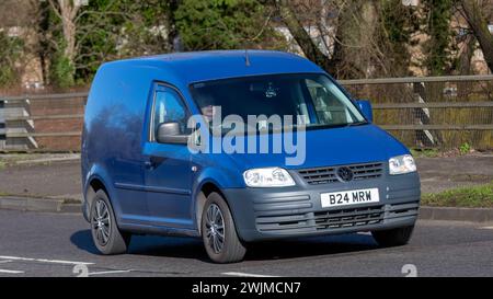 Milton Keynes,UK-Feb 13th 2024: 2010 blue diesel Volkswagen Caddy van driving on an English road Stock Photo