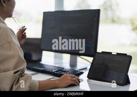 Developer programmer working to checking code on monitor while programming to developing website. Stock Photo