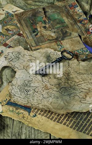 An old style key laying on old hand drawn maps and old manuscripts. Treasure hunter history mystery adventure. Stock Photo