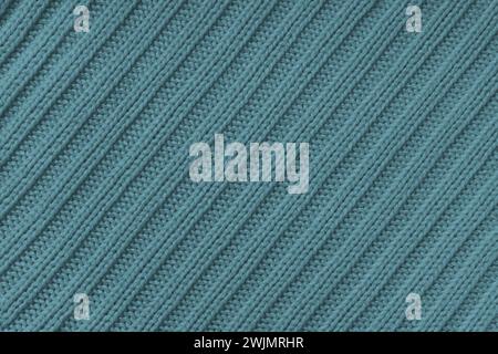 Jersey textile background , green-gray diagonal striped knitted fabric. Woolen knitwear, sweater, pullover surface texture, textile structure, cloth s Stock Photo