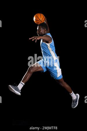 African American man in mid-air basketball action Stock Photo