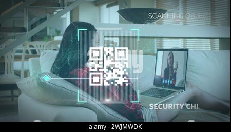 Image of qr code security check over woman using laptop on image call Stock Photo